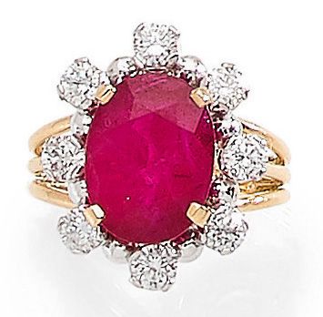 null MAUBOUSSIN RING set with a Burmese ruby, surrounded by brilliant-cut diamonds....
