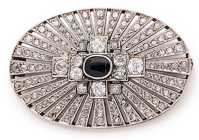 null An oval-shaped brooch holding a sapphire of approximately 0.50 carat, set with...