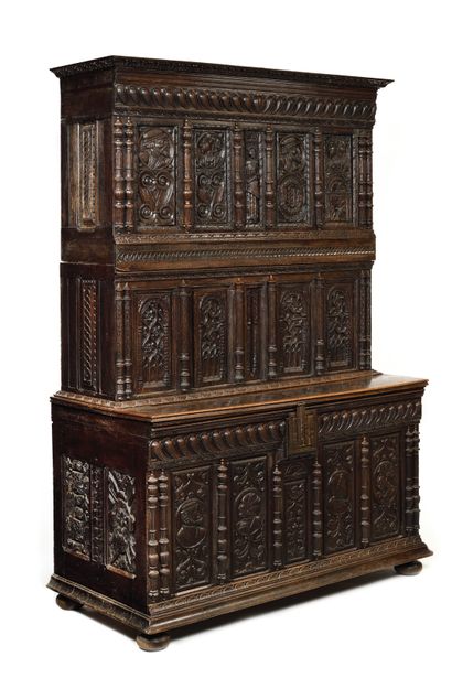 IMPORTANT CARVED OAK FURNITURE with a recessed...