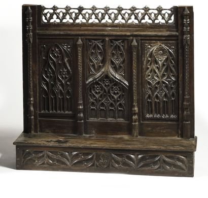  DRESSER Carved oak chest of drawers with a trapezoidal plan decorated with arches...