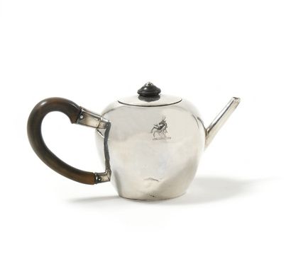 null A plain silver flat-bottomed round teapot, engraved with a crest showing a deer...