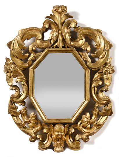 null A Pair of carved and gilded wood mirrors, octagonal shape, surrounded by foliage,...