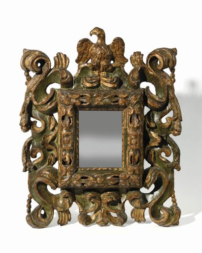 null A poplar wood mirror carved in high relief and openwork painted in green and...