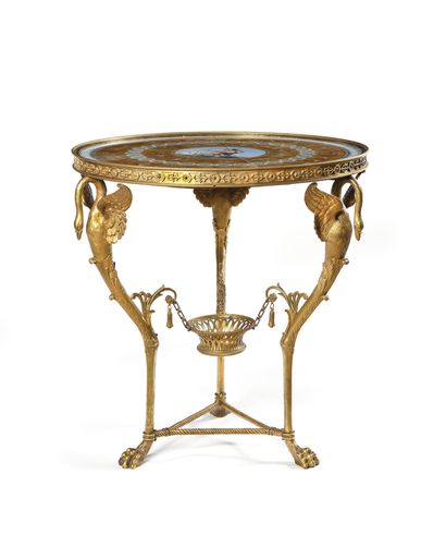 null A round ormolu GUERIDON, the top with polychrome decoration under glass in imitation...