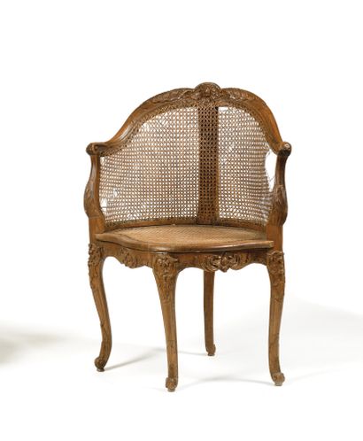 null * A molded and carved beechwood desk chair with pomegranate, rocaille, foliage...