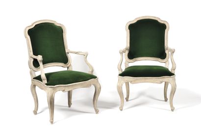 null A Pair of moulded and painted wood armchairs, the flat back resting on cambered...