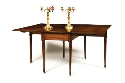 null * A rectangular molded mahogany LIBRARY TABLE in the Joseph Canabas style, with...