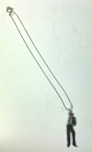  CHANEL 
Long necklace with a pendant representing a mannequin wearing a jacket with...