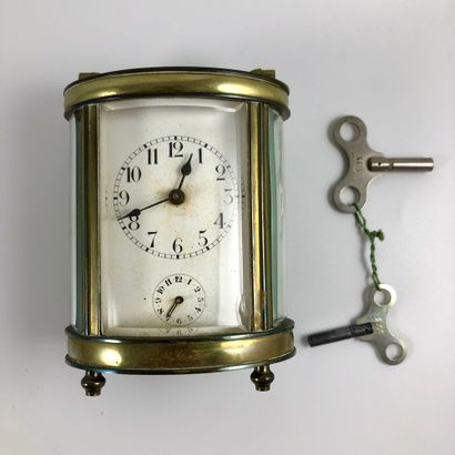  OFFICER'S CLOCK. Oval shaped clock. Apparent mechanism. Alarm clock function. Enamelled...
