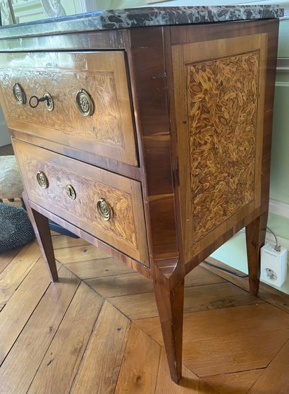  A cytise veneered chest of drawers with two drawers in the front, the uprights with...