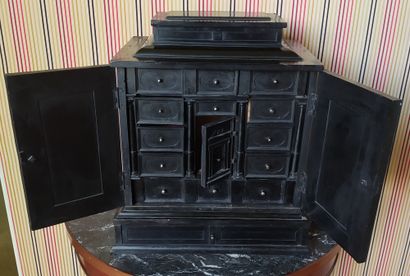null An ebony veneered CABINET opening on the front with two leaves, the sides with...