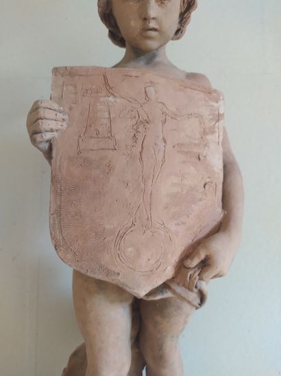  PAIR OF STATUES of draped children in terracotta. Each one has a decorated shield....