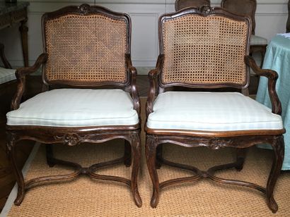 null A PAIR OF ARMCHAIRS with an agitated back, in natural wood moulded and carved...
