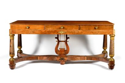 null A mahogany veneered CLAVECIN desk with three drawers opening on the waist and...