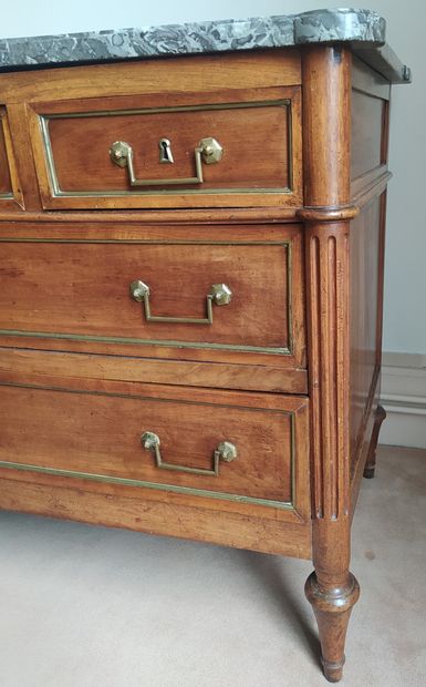  A natural wood moulded chest of drawers, with fluted uprights, opening to five drawers...