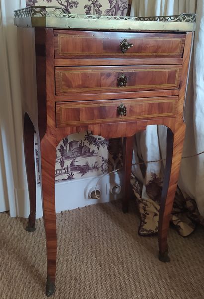null A satinwood, fruitwood and green tinted wood veneer chest of drawers with three...