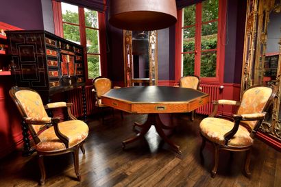 null Octagonal LIBRARY TABLE in lemon tree veneer, the banded belt opening to four...