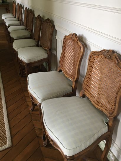null A SET OF TEN MOVED BACK CHAIRS, in natural wood moulded and carved with flowers,...