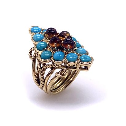 null A diamond-shaped ring holding four citrines in a circle of cabochon turquoise....