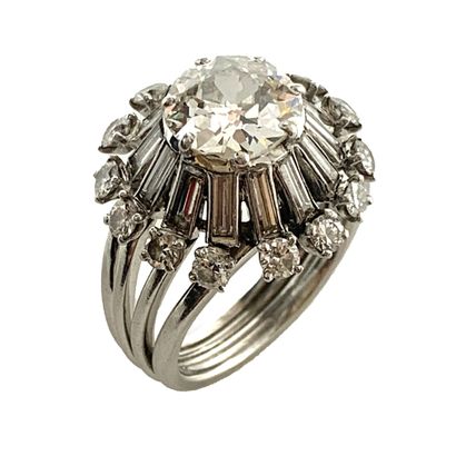 null RING holding in its center a 2.22 carat old cut diamond in a setting of baguette...