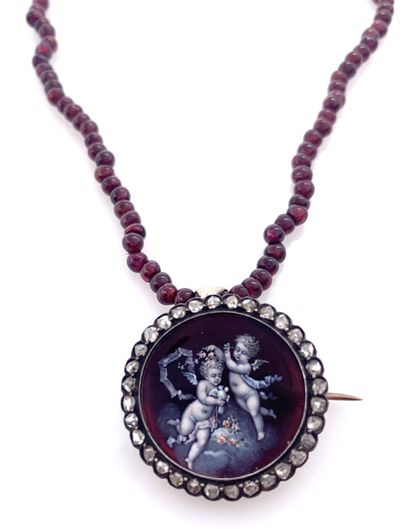 NECKLACE with an enamelled cherub pendant...