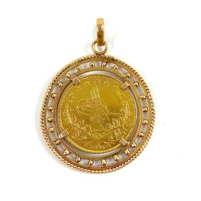 null MEDALLion holding a coin in a circular setting. Mounted in 18K yellow gold....
