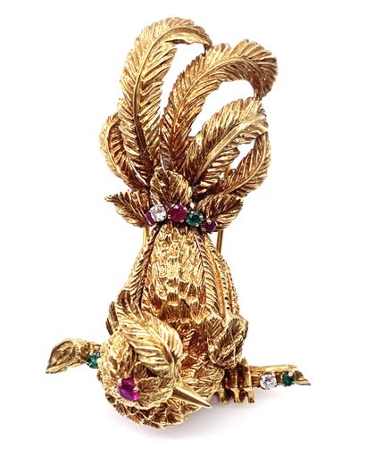 null A brooch holding a bird design adorned with brilliant-cut diamonds, rubies and...