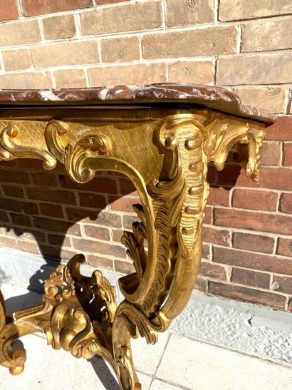 null CONSOLE of movement form in gilded wood moulded and carved with staples, flowers...