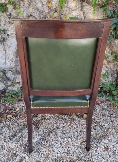 null A mahogany desk chair with straight back, the armrests with caryatid busts,...