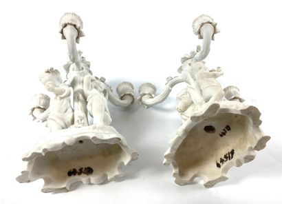 null Pair of candelabra in biscuit with three arms of light decorated with cherubs...
