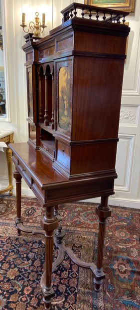 null Mahogany veneered CABINET opening in the waist by a central drawer and presenting...