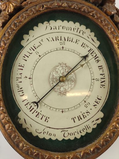 null BAROMETER in green lacquered wood and gilded with carved flowers on the pediment...