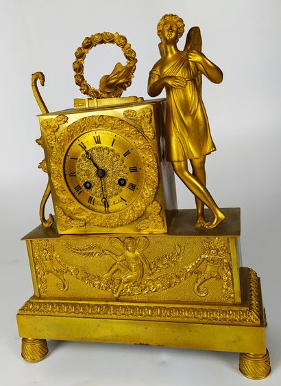  A gilt bronze and chased clock decorated with Cupid and his attributes. The gilt...