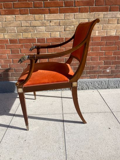 null Mahogany armchair with a slightly overturned backrest, the armrests ending in...