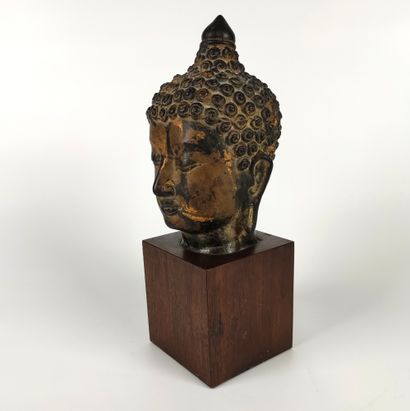 null 
CHINA
Beautiful gilt bronze Buddha head with brown patina, the eyes half closed...