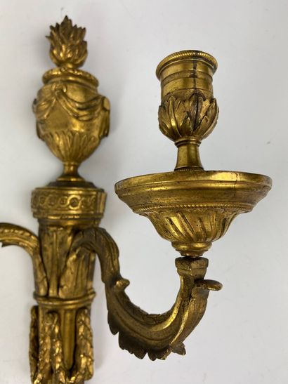 null Pair of gilt bronze and chased sconces with two arms of lights topped by a fire...