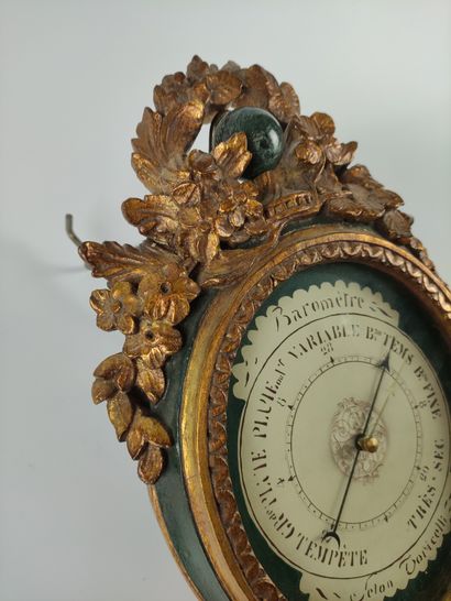 null BAROMETER in green lacquered wood and gilded with carved flowers on the pediment...