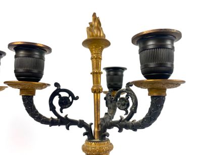 null A PAIR OF CANDELABRES in ormolu and patina decorated with cherubs holding three...