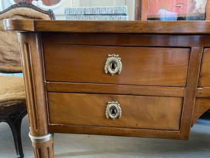 null A mahogany flat desk with side pulls opening with four drawers and boxes in...