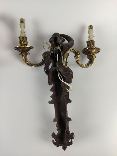 null Pair of bronze sconces with brown patina and decoration of busts of women holding...