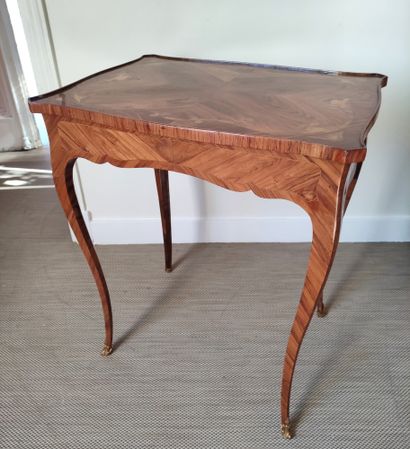 null A veneer and rosewood marquetry SALON TABLE opening with two side drawers, the...