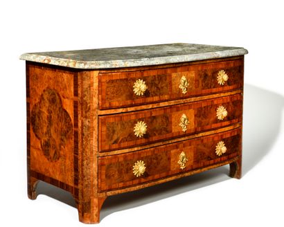 null A veneer and marquetry chest of drawers opening on the front with three drawers...