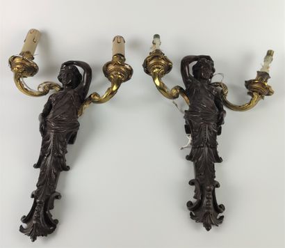 null Pair of bronze sconces with brown patina and decoration of busts of women holding...
