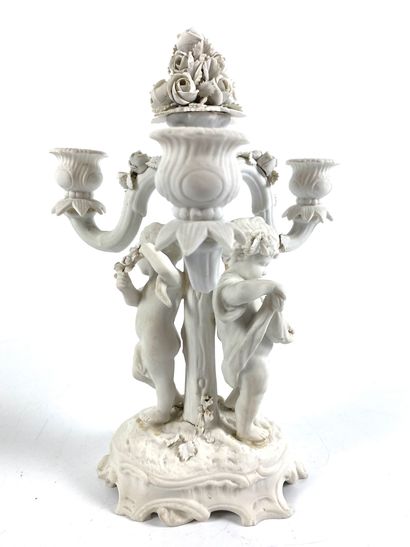 null Pair of candelabra in biscuit with three arms of light decorated with cherubs...