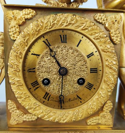  A gilt bronze and chased clock decorated with Cupid and his attributes. The gilt...