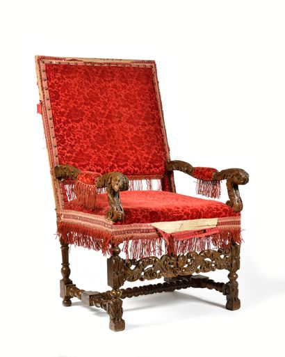 null A carved and stained beechwood armchair, with a flat back fully covered, the...