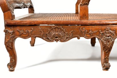null A carved beechwood cane chair with a flat back and openwork shoulder in the...