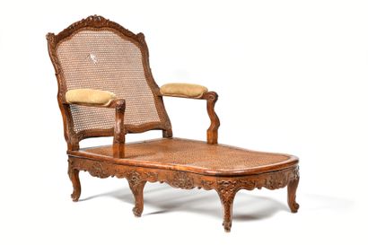 A carved beechwood cane chair with a flat...