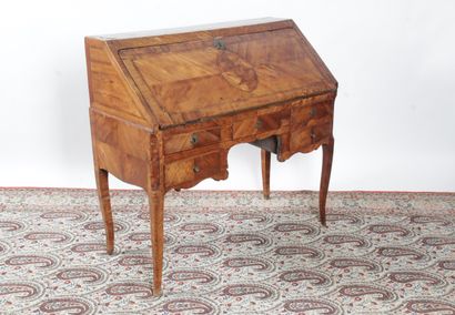 null A LOUIS XV period sloping desk, in marquetry of frieze, the flap decorated with...