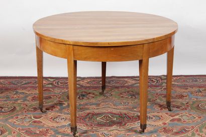 null Half moon table in walnut and walnut veneer. It rests on five tapered legs ending...